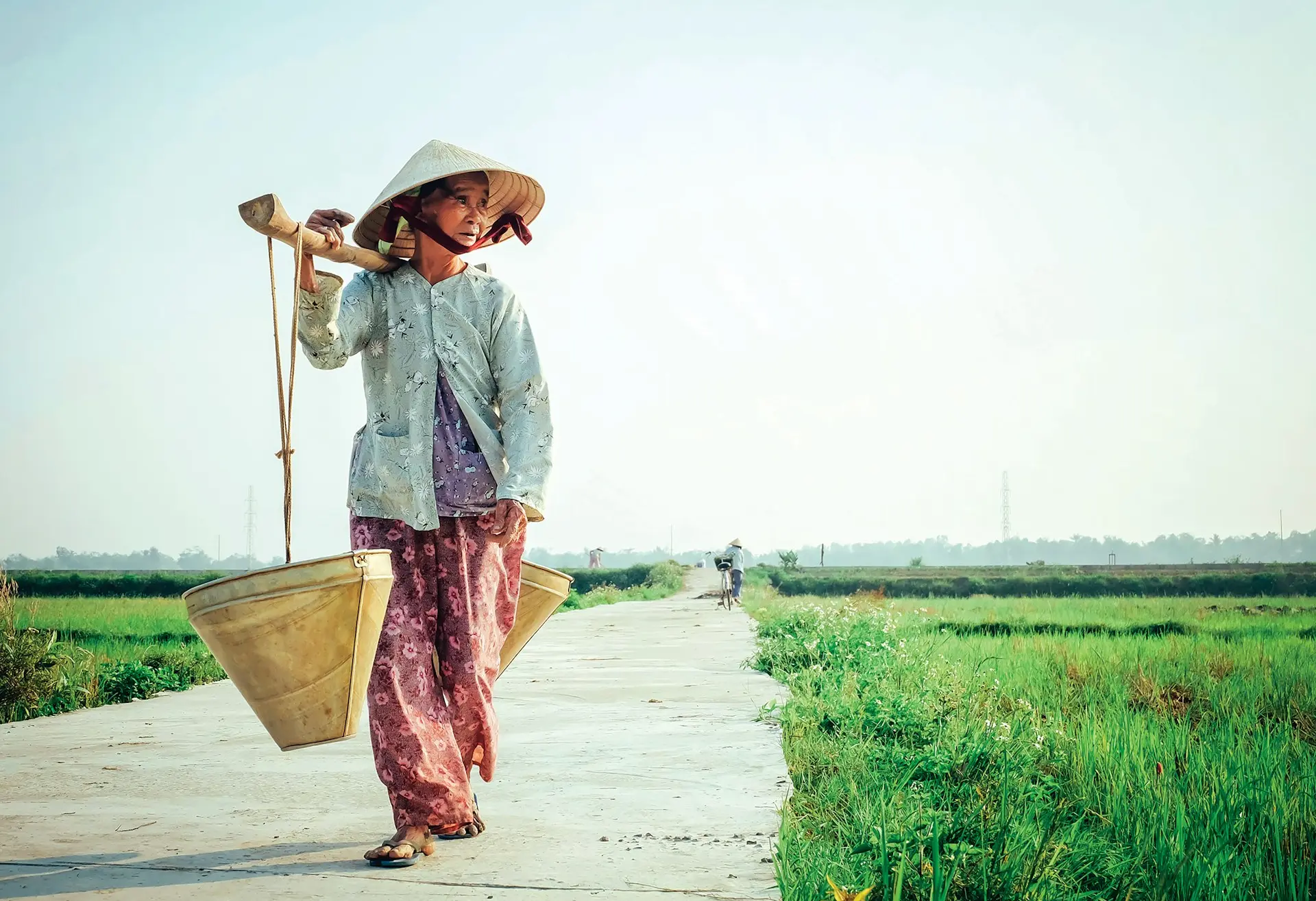 woman carrying basket on her shoulder