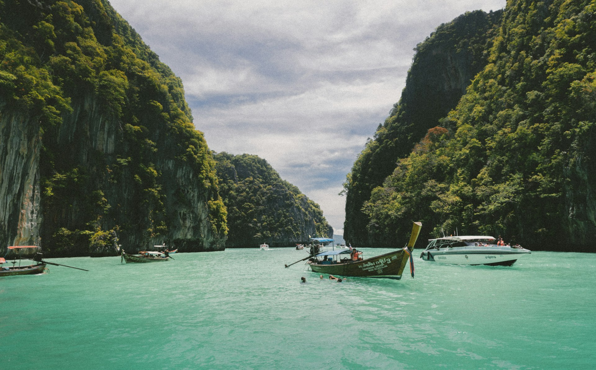 four wooden boat on teal sea