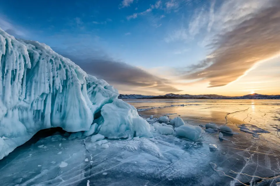 ice formation on body of water under blue sky during daytime